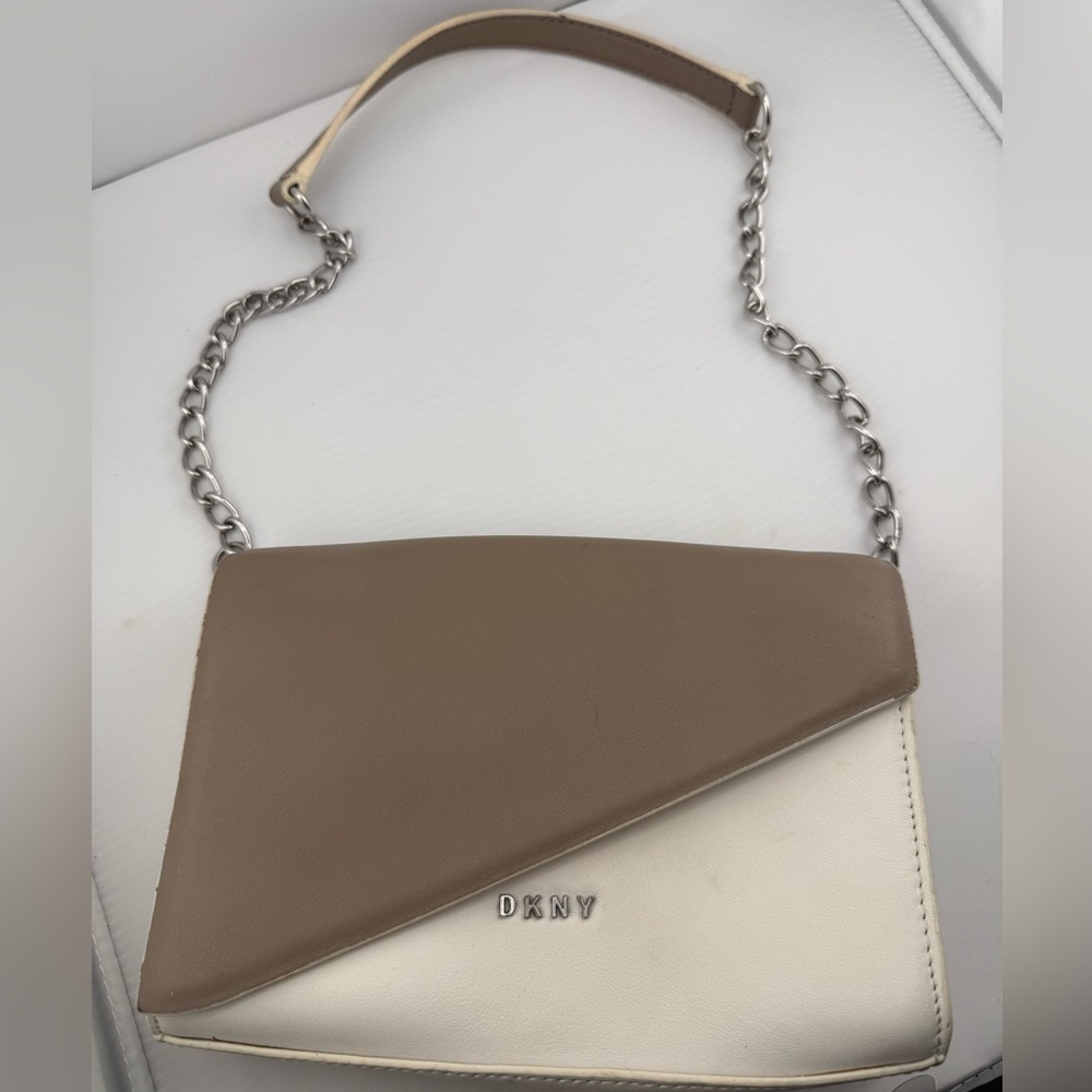 This is a DKNY cream and tan leather crossbody bag.